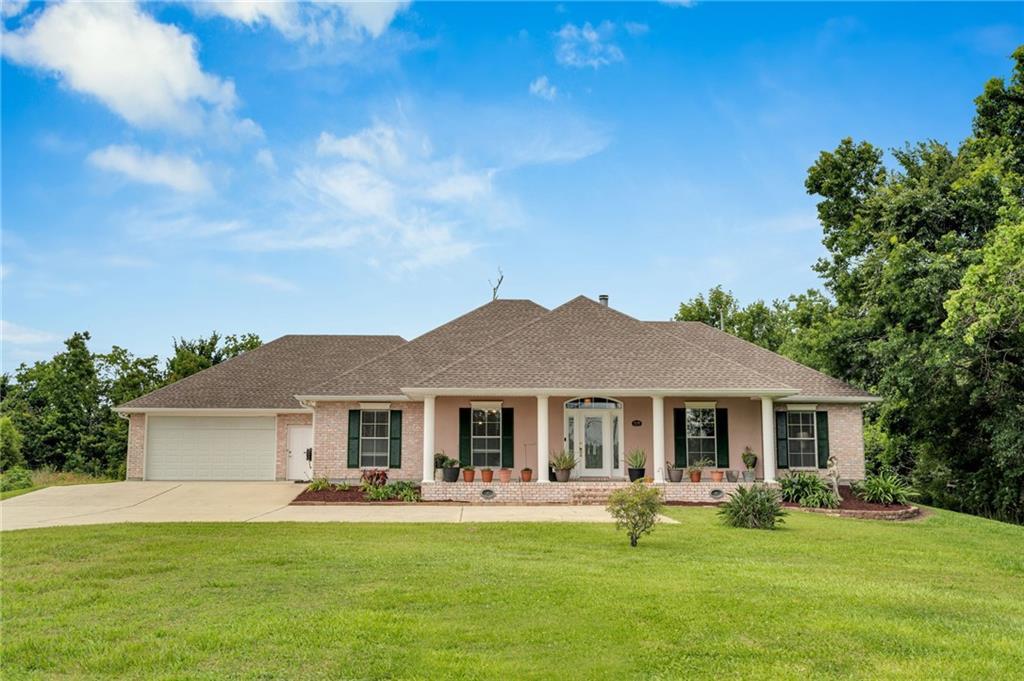 Image 2: Covered front porch with additional driveway and l