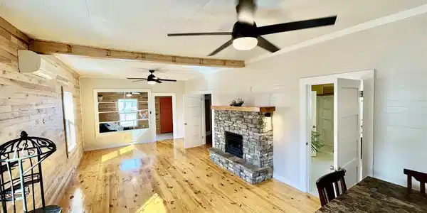 Image 2: Warm woods. Spacious living and foyer.