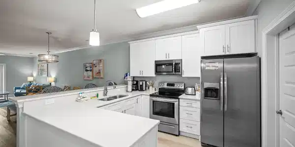 Image 3: Kitchen with a door to the downstairs laundry.