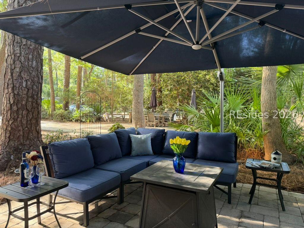 Image 3: L-shaped sofa surrounds fire table and end tables