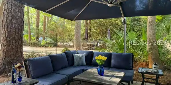 Image 3: L-shaped sofa surrounds fire table and end tables Image 3: L-shaped sofa surrounds fire table and end tables