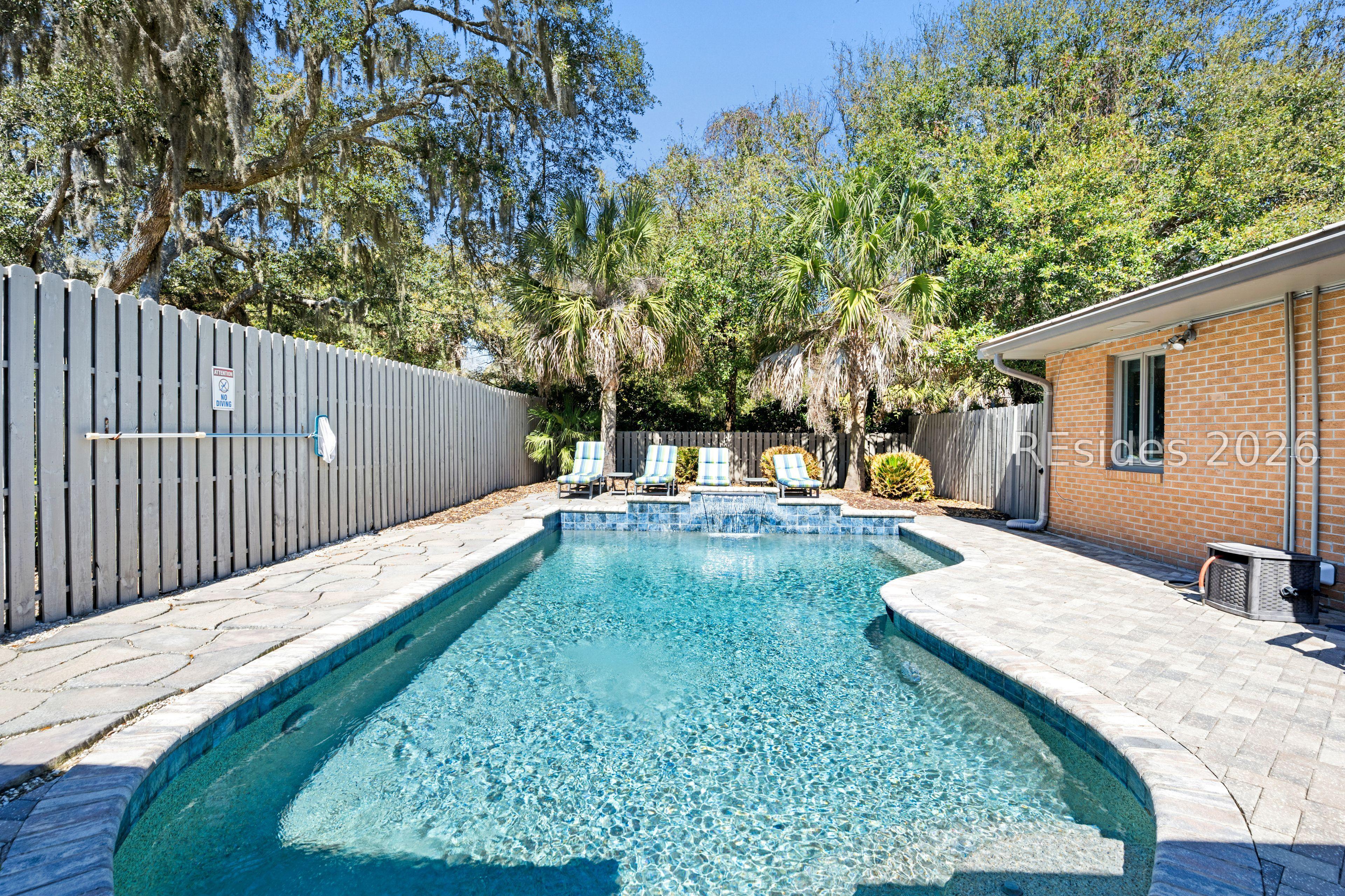 Image 2: Cool off in the water or lounge on the paver patio