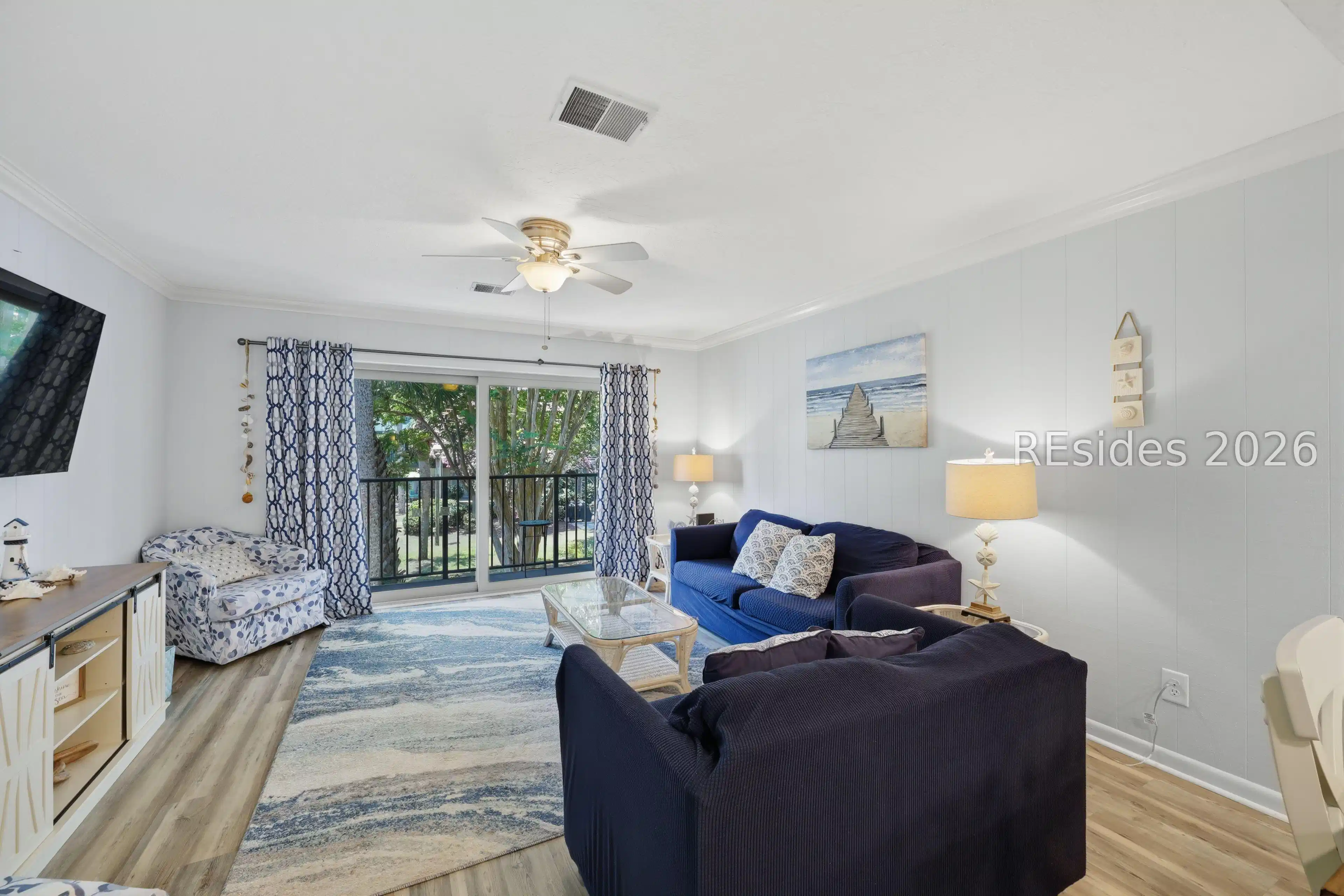Image 1: Ample sized living space, with deck access.