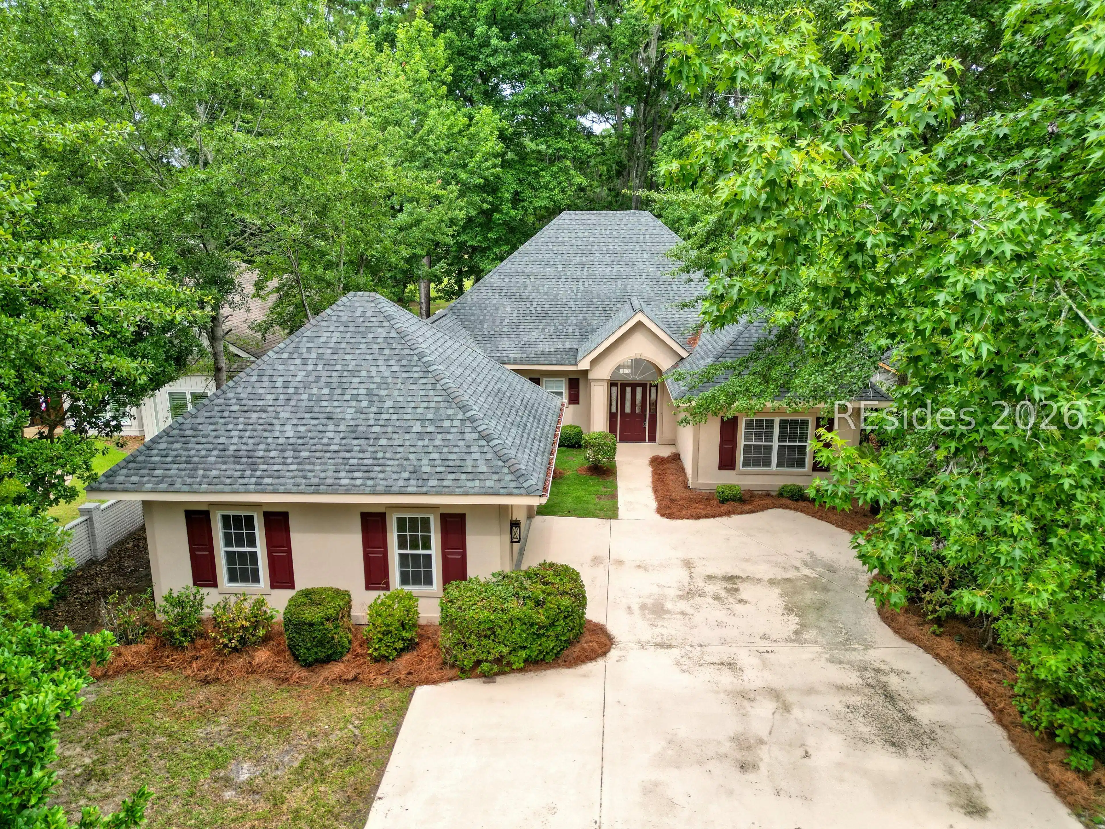 Image 1: Front view. Home surrounded by mature trees. Image 1: Front view. Home surrounded by mature trees.
