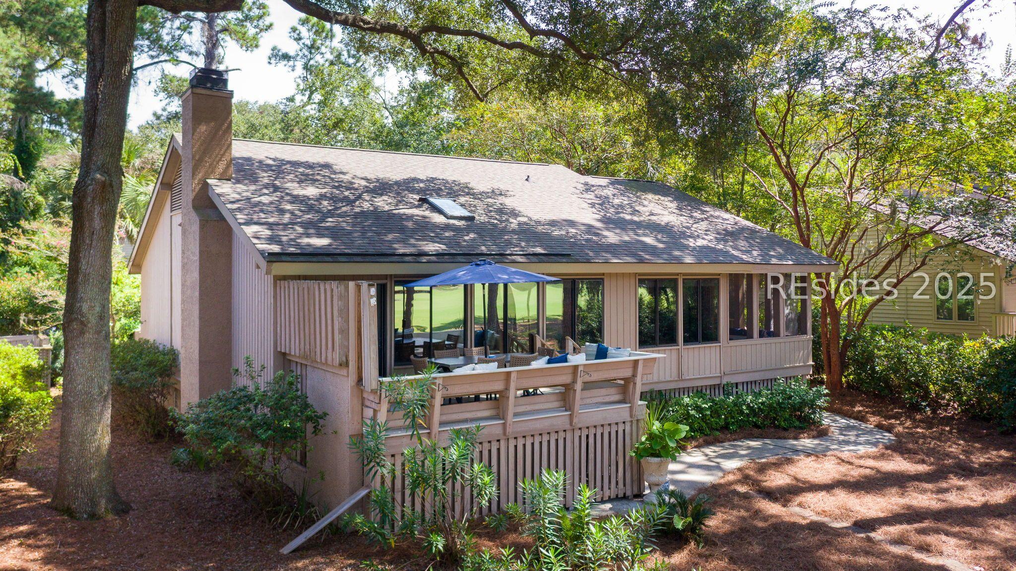 Image 3: Back elevation with deck & golf views.