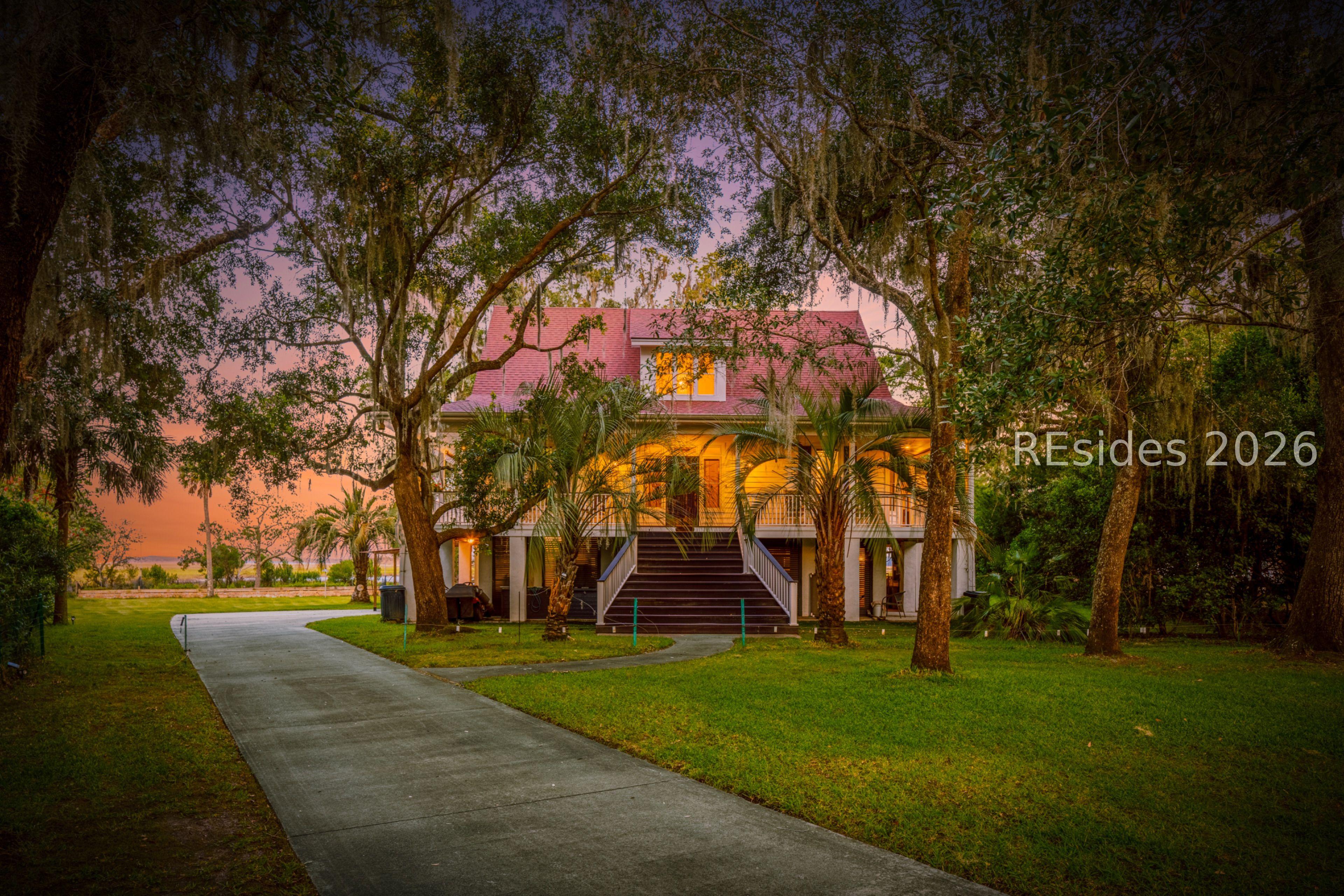 Image 3: Front of Home tucked under the Live Oaks Image 3: Front of Home tucked under the Live Oaks