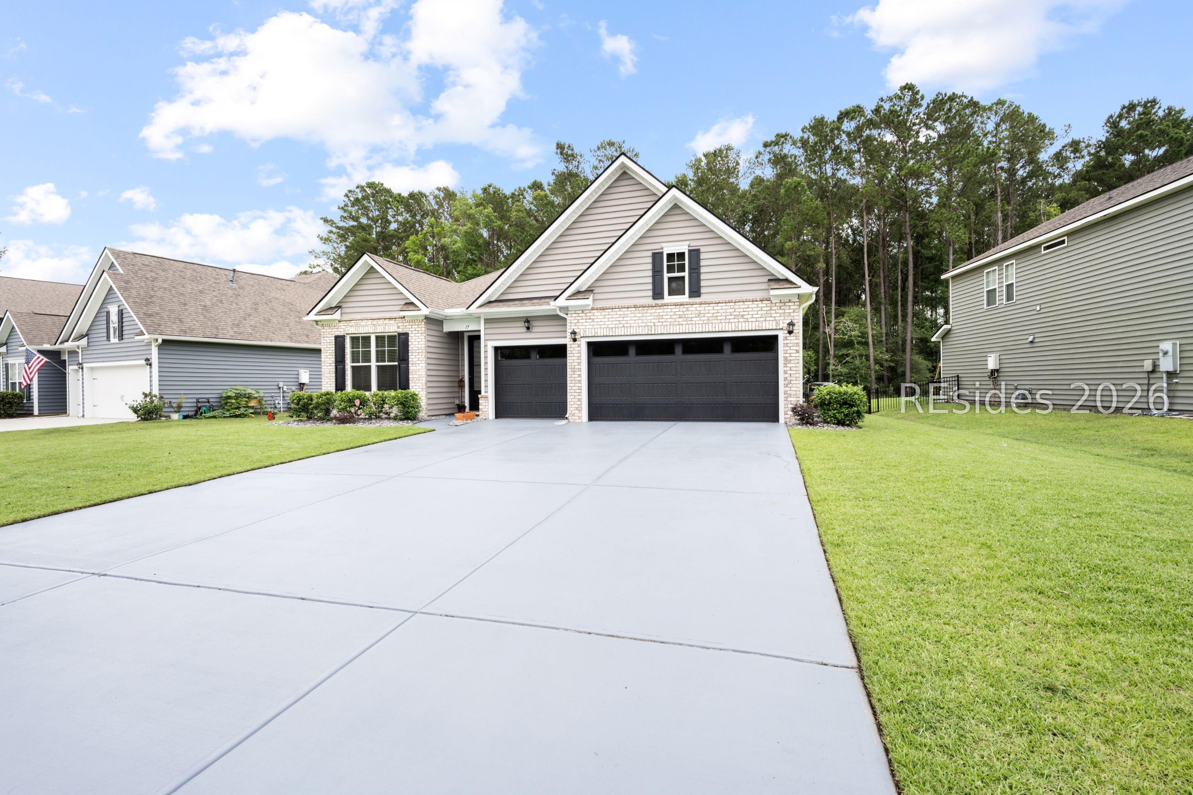 Image 2: 3-Car Garage and Painted Driveway