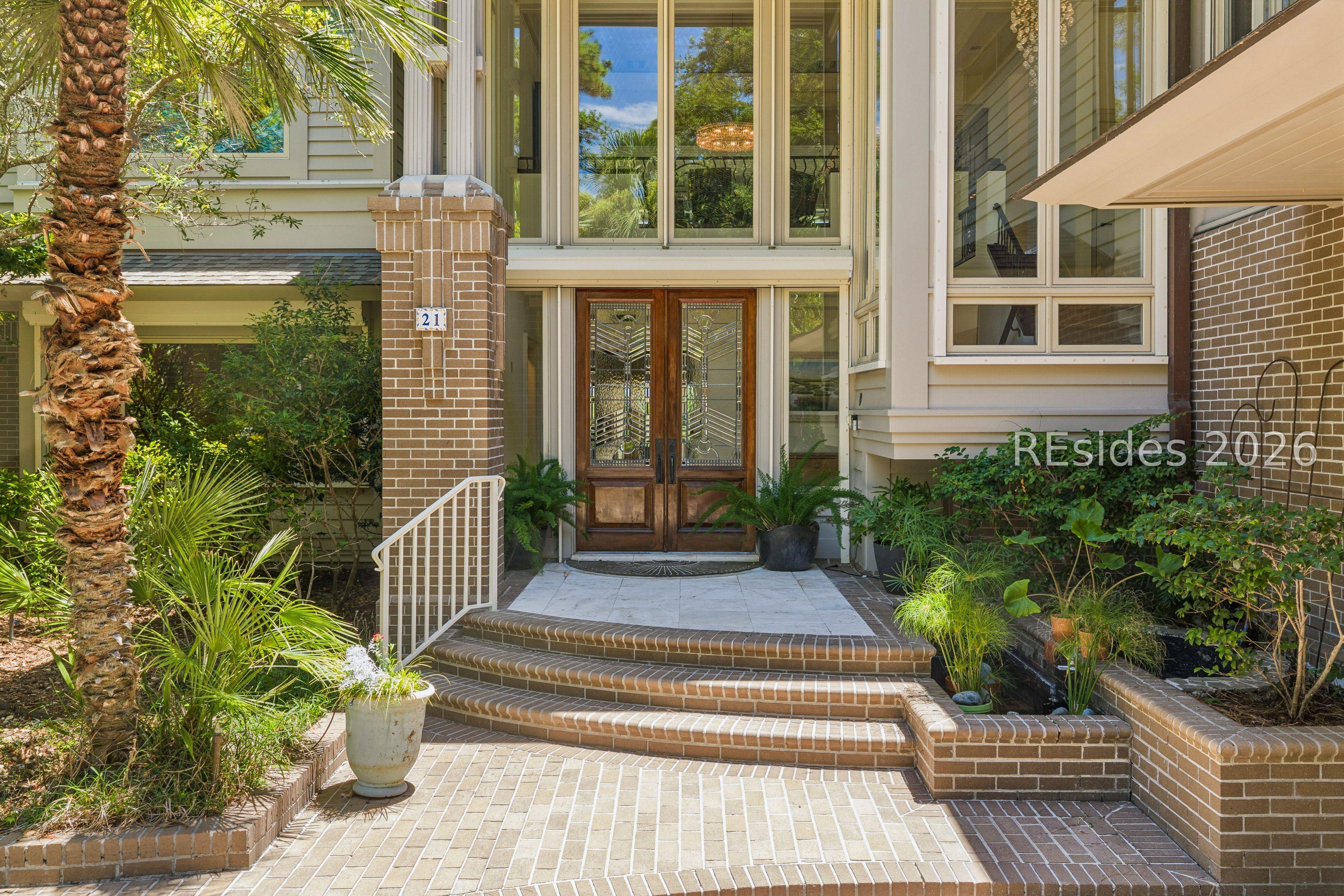 Image 3: Expansive windows and a Koi pond welcome