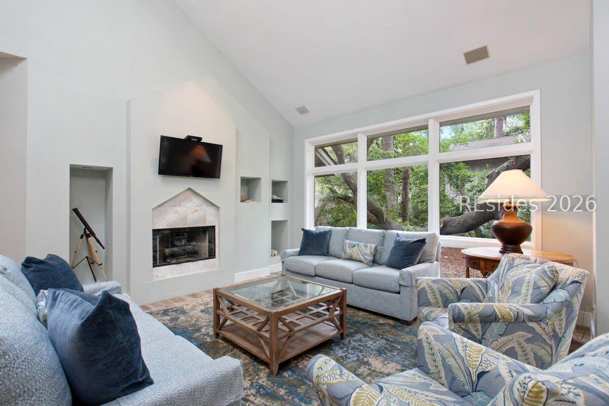 Image 4: Tons of windows allow in natural light in the LR