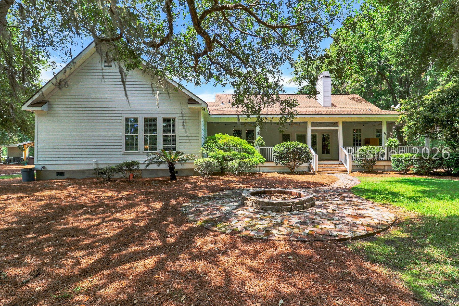Image 2: Back of Home with Beautiful Live Oaks and Fire Pit Image 2: Back of Home with Beautiful Live Oaks and Fire Pit