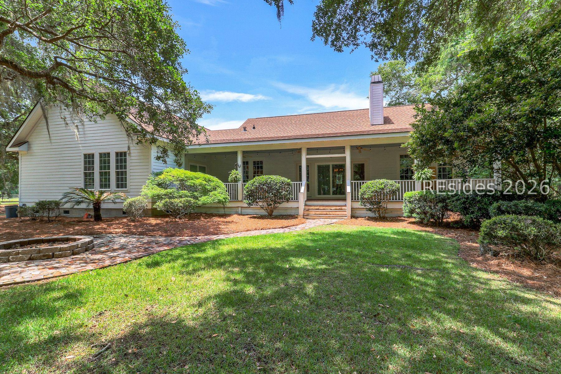 Image 3: Back of Home with Beautiful Live Oaks and Fire Pit Image 3: Back of Home with Beautiful Live Oaks and Fire Pit
