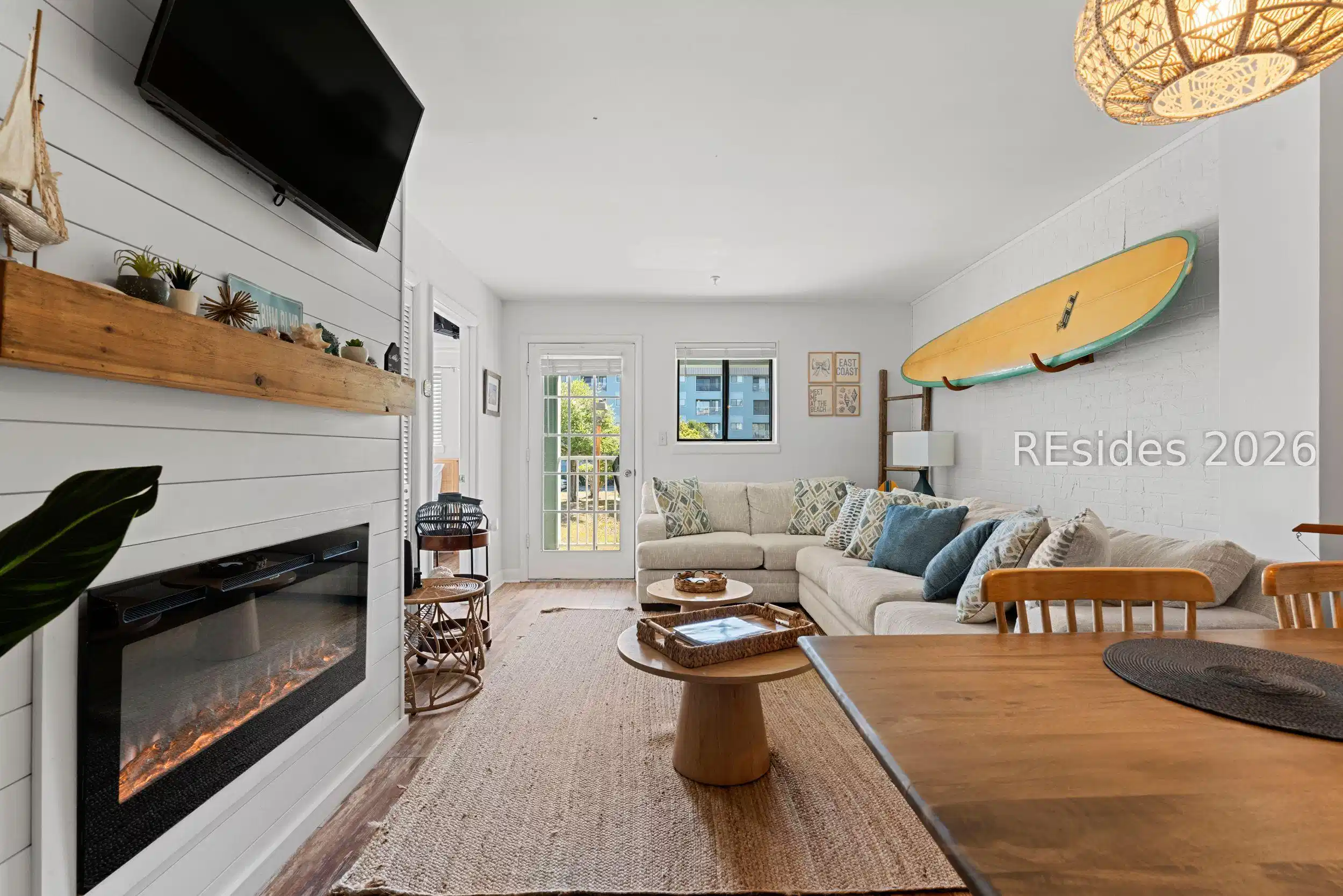 Image 1: Living Room with Glass-Enclosed Electric Fireplace Image 1: Living Room with Glass-Enclosed Electric Fireplace
