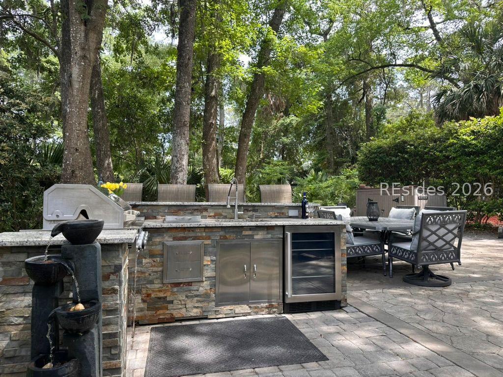 Image 3: Water feature by outdoor kitchen on paver patio
