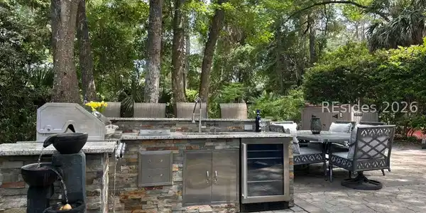 Image 3: Water feature by outdoor kitchen on paver patio