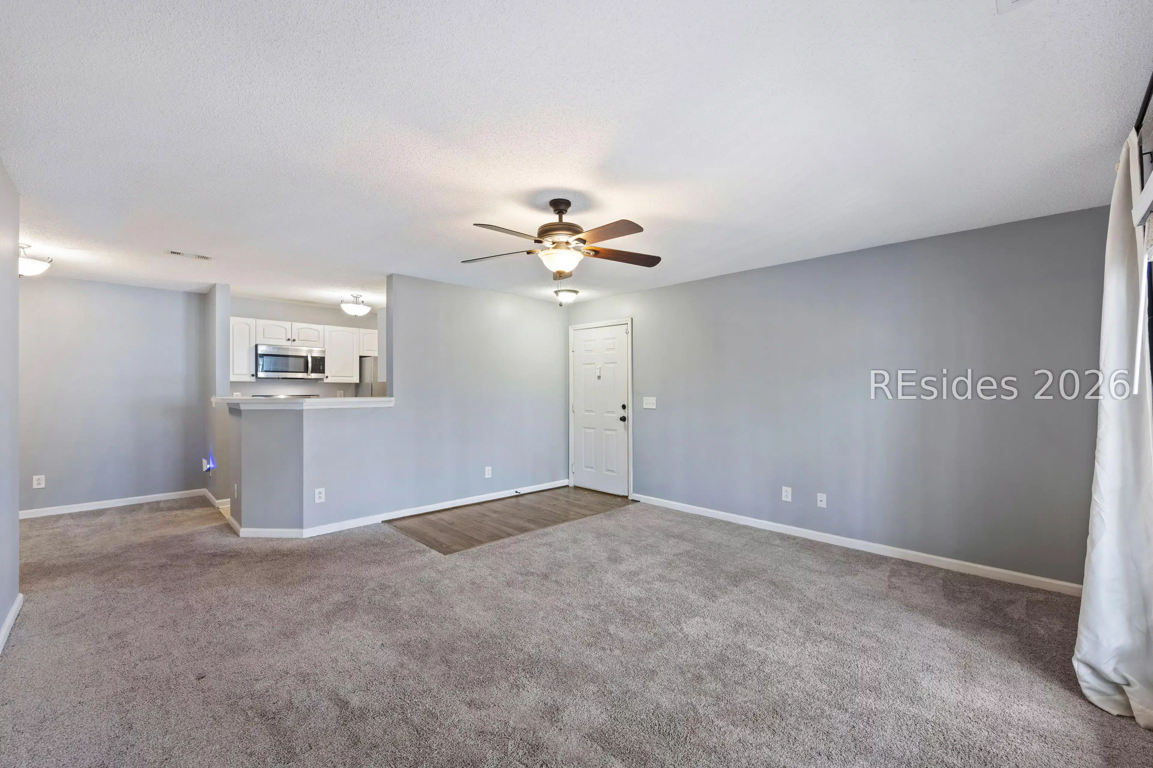 Image 1: Spacious living area overlooks woods. Image 1: Spacious living area overlooks woods.