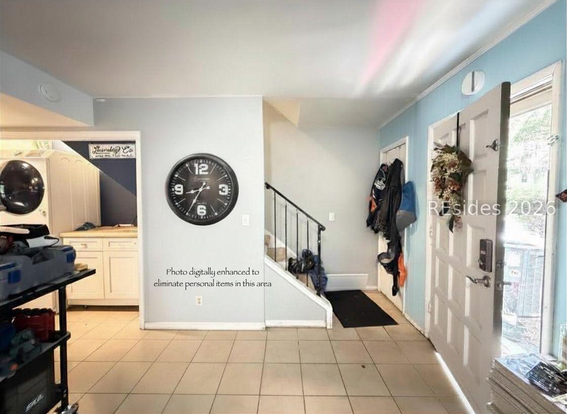 Image 3: Hall closet & stairs with laundry on left
