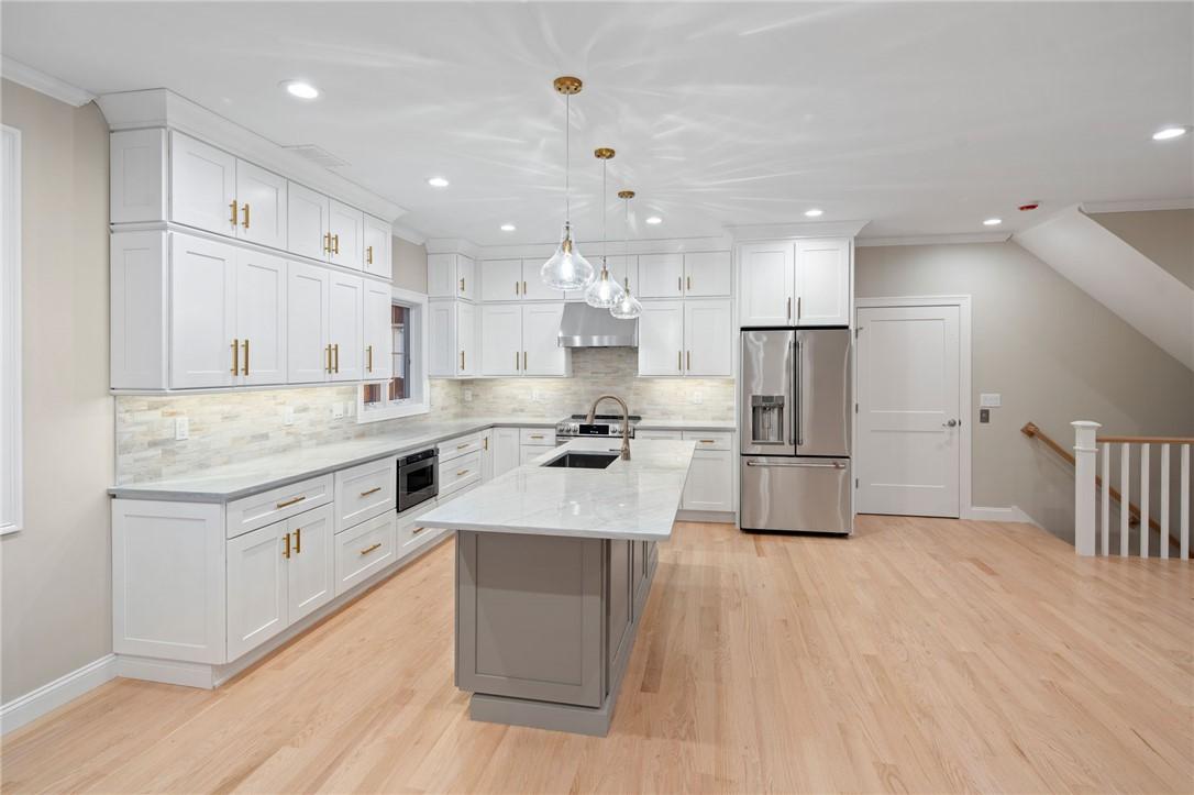 Image 4: The door to the right of the refrigerator is the e