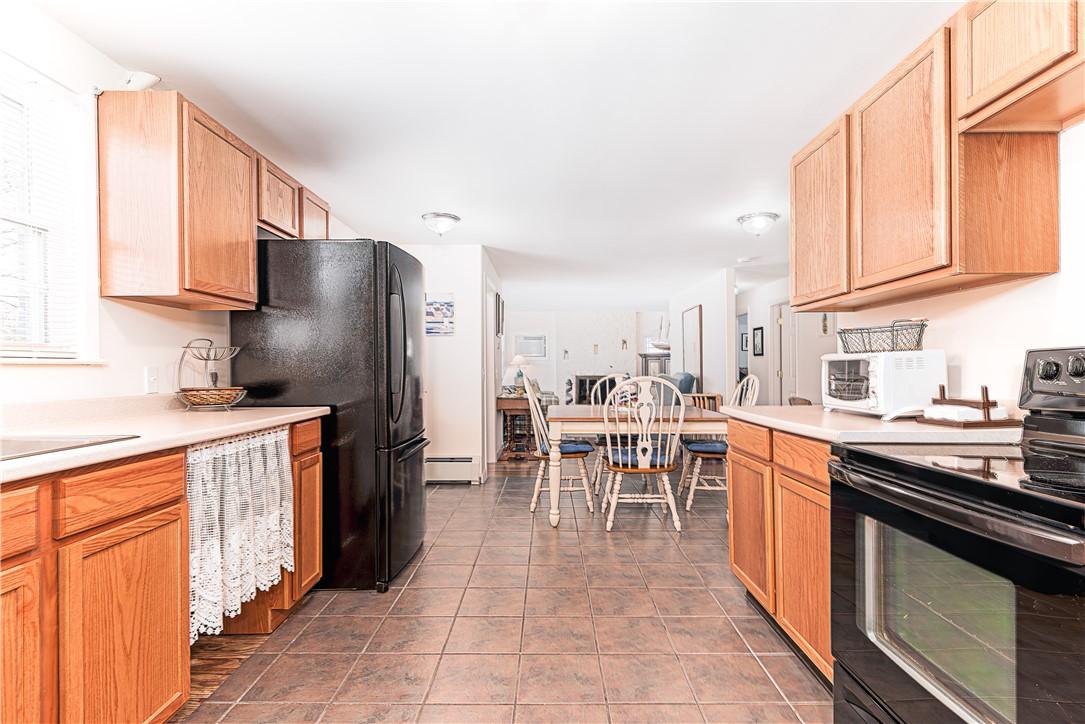 Image 2: Lots of cabinets and counterspace!   Tile floor