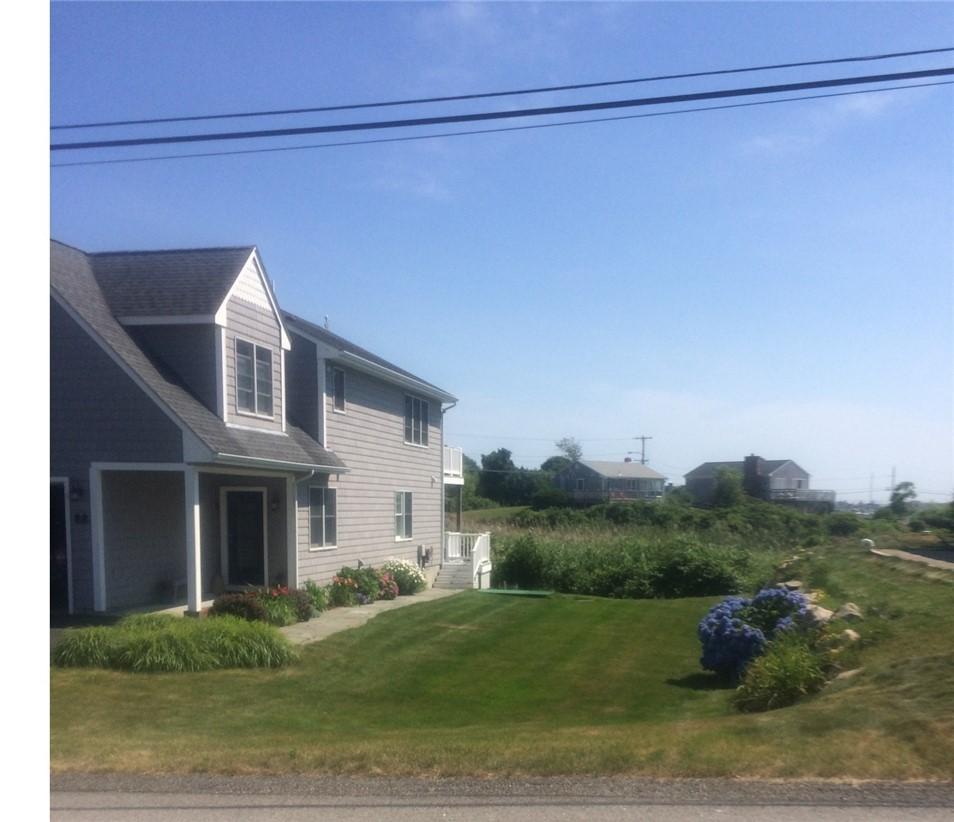 Image 2: Side view of home and its entry that showcases the