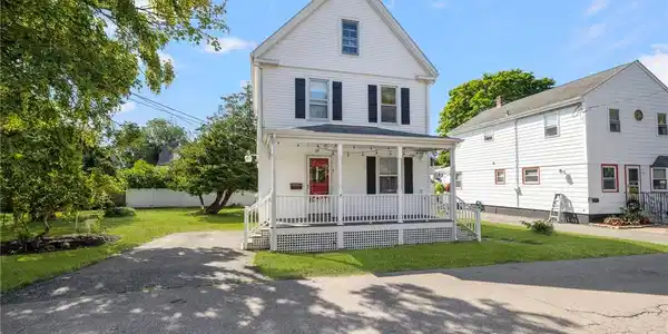 Image 2: Front exterior showing parking/driveway at 9 Cummi