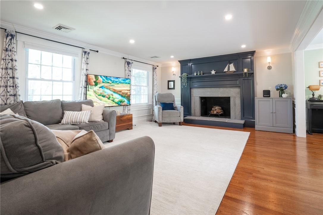 Image 3: Living room with fireplace and hardwoods