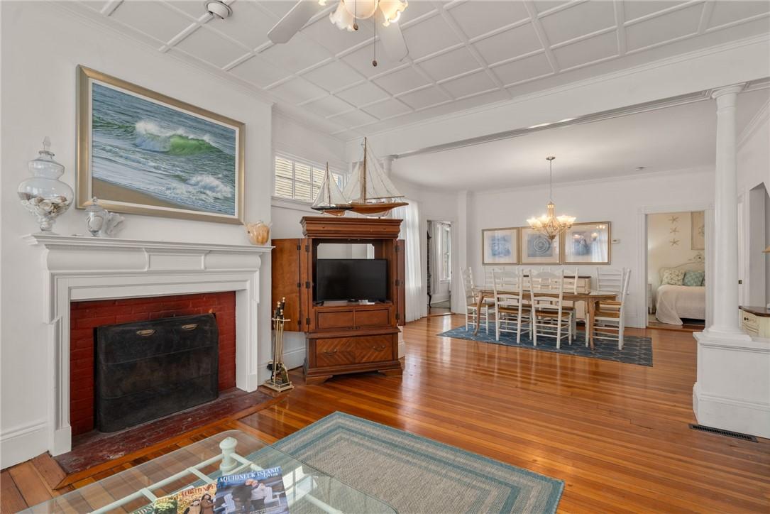 Image 3: Unit 1 has Wood floors, a wood burning fireplace a