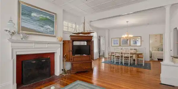 Image 3: Unit 1 has Wood floors, a wood burning fireplace a