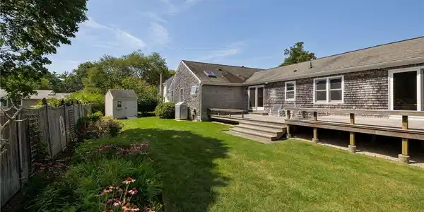 Image 2: Private yard with sprawling deck