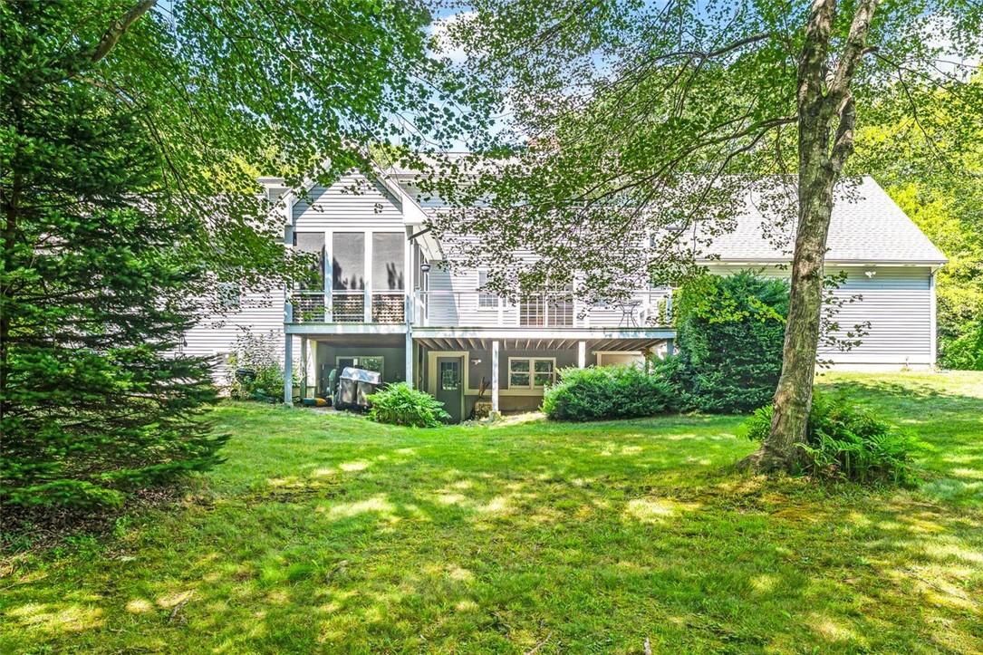 Image 4: The back of the house looks out on beautiful lawn