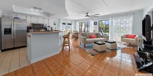 Image 4: Open Kitchen-Dining-Living Areas, Tile flooring throughout.
One style for Kitchen. One style for Dining-Living.
Lots of floor to ceiling glass for natural light.