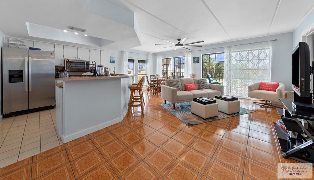 Image 4: Open Kitchen-Dining-Living Areas, Tile flooring throughout.
One style for Kitchen. One style for Dining-Living.
Lots of floor to ceiling glass for natural light.