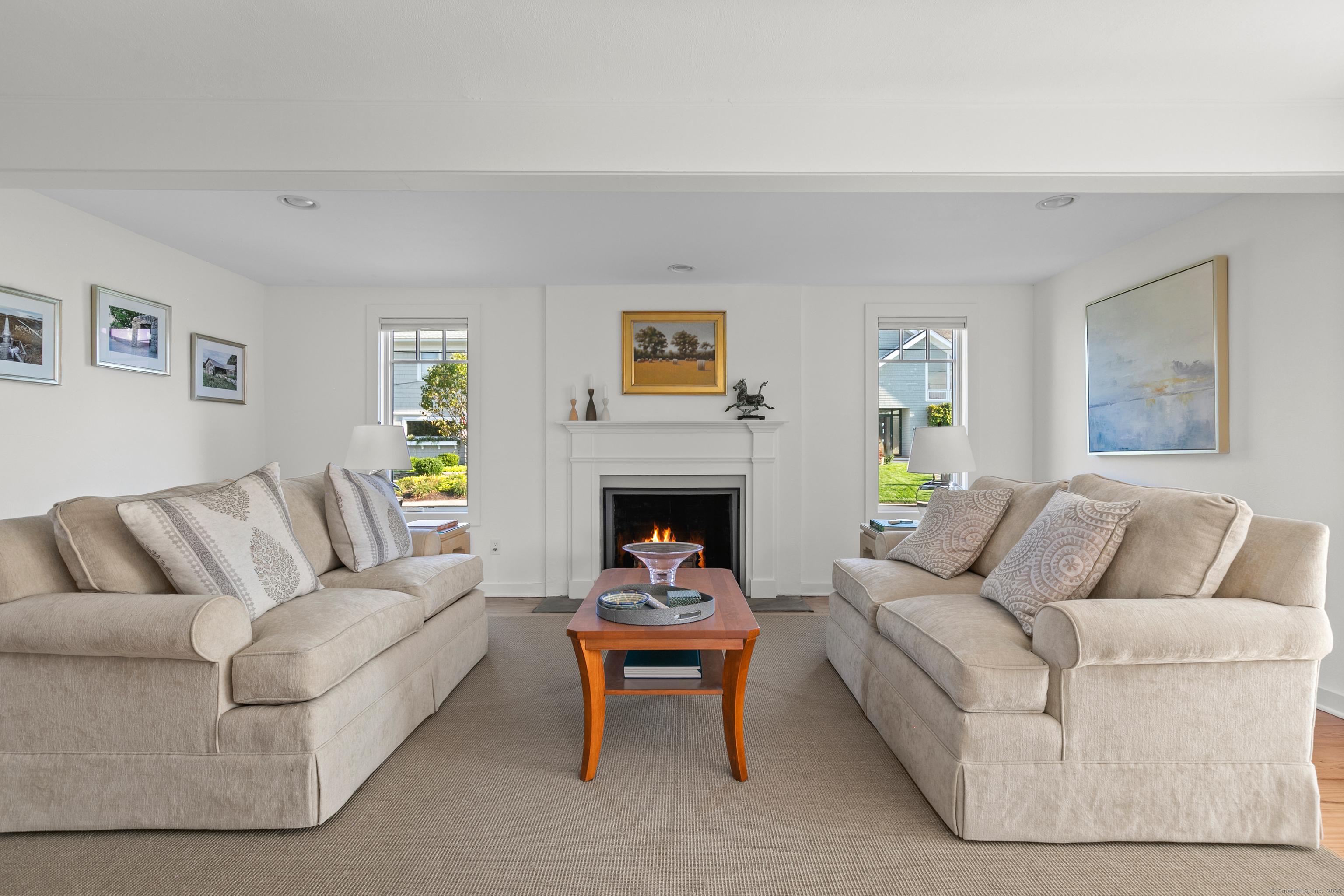 Image 3Living Room: Welcoming living room has wood burning fireplace to add ambiance and warmth to the room.