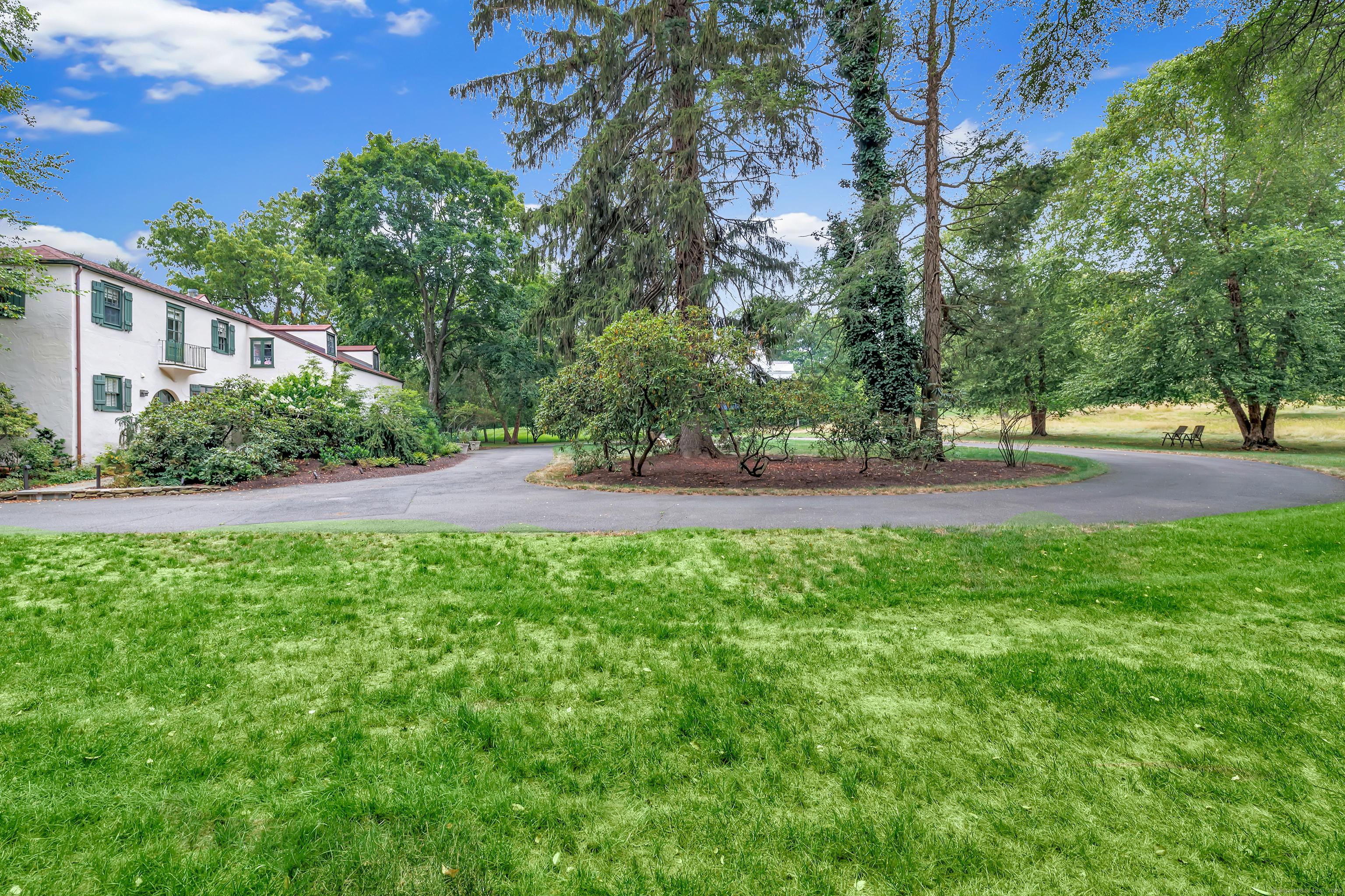 Image 3: Meadow views and mature trees on a sprawling level lot.