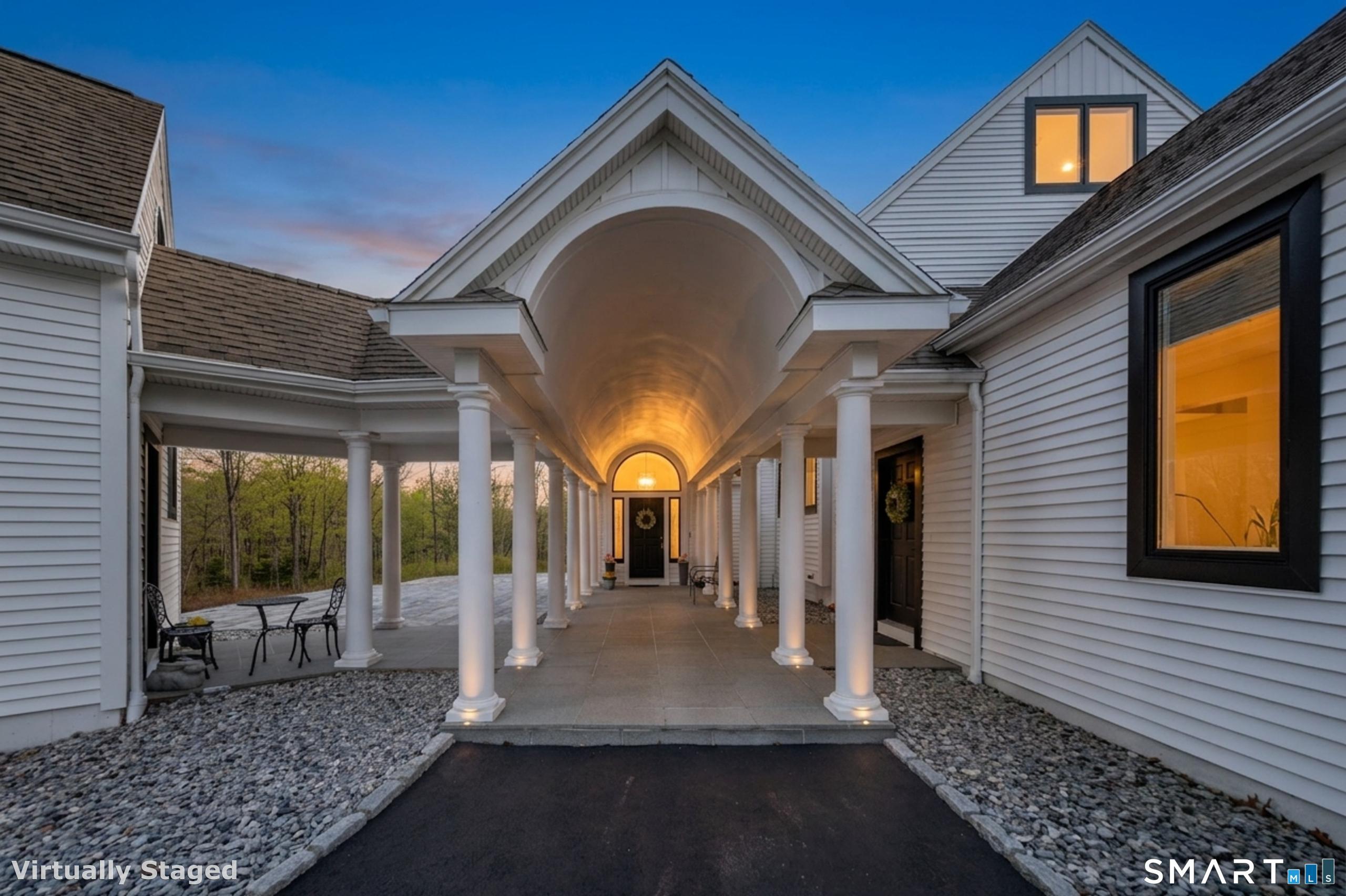Image 2: This stunning covered entrance allows entrance to the main home and the guest apartment.
