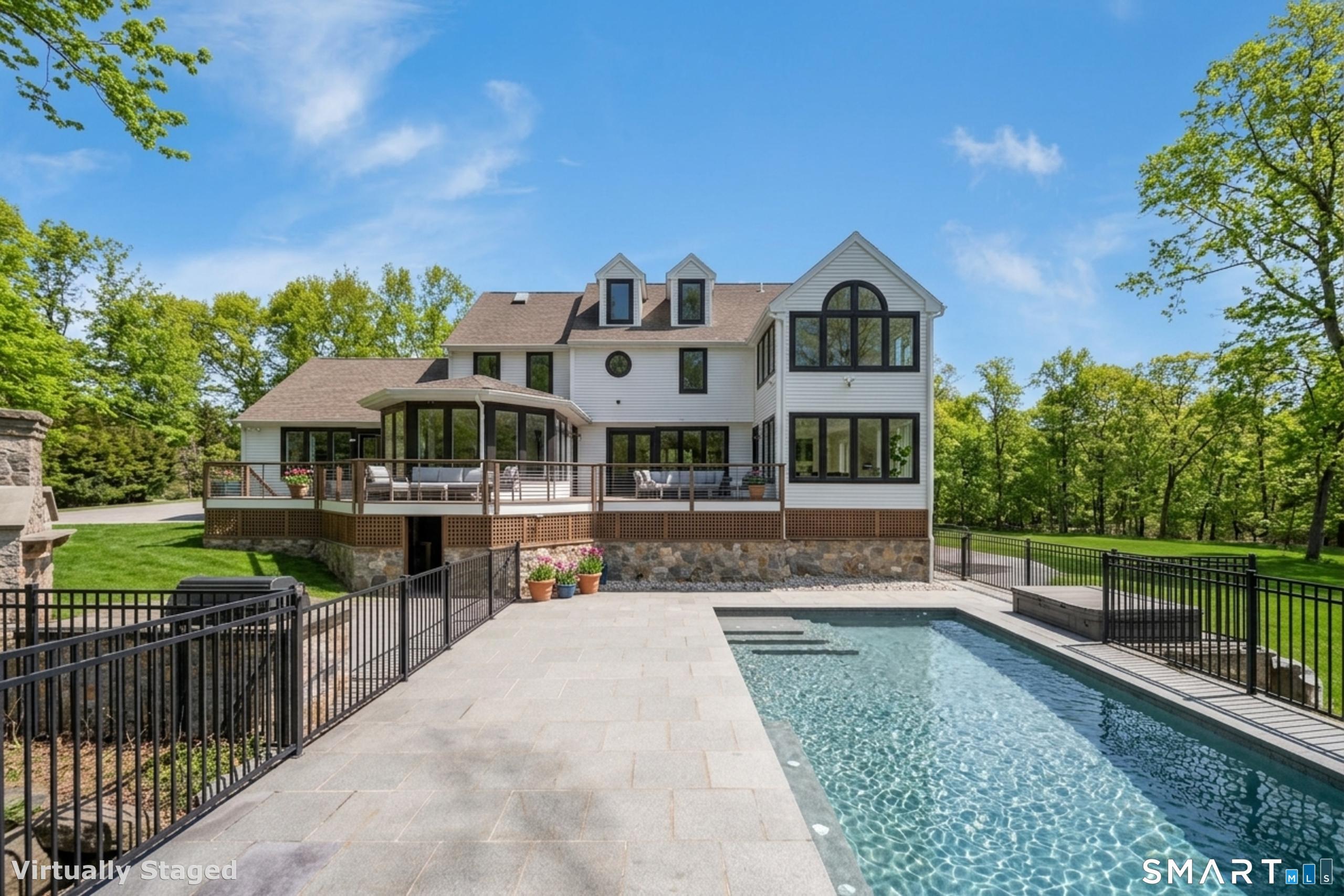 Image 3: The landscaping includes two outdoor kitchens, a gunite pool, multiple spacious patios, playground, and garden areas
