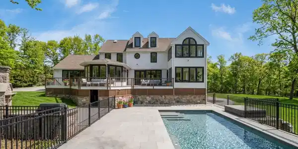 Image 3: The landscaping includes two outdoor kitchens, a gunite pool, multiple spacious patios, playground, and garden areas