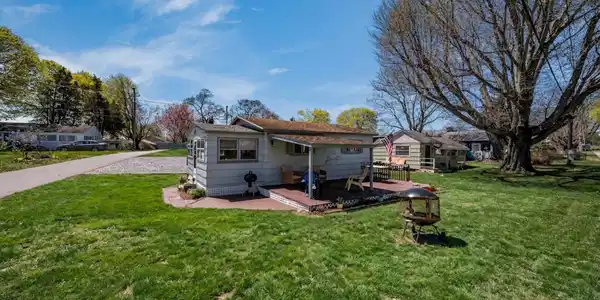 Image 3: Generously-sized deck perfect for summer entertaining! Grass enhanced