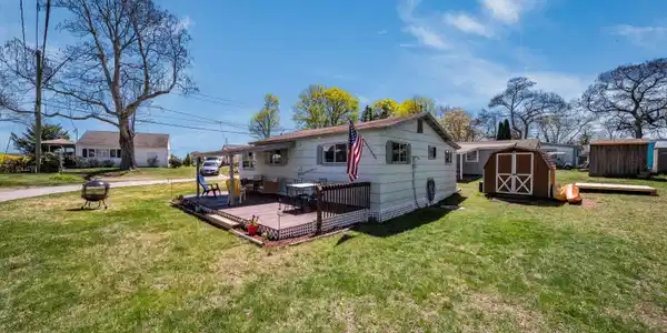 Image 4: Backyard equip with a storage shed and outdoor shower!