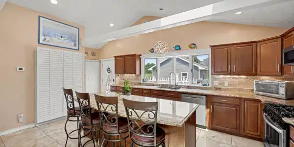Image 2Kitchen: Chef's kitchen with granite countertops and center island for entertaining.
