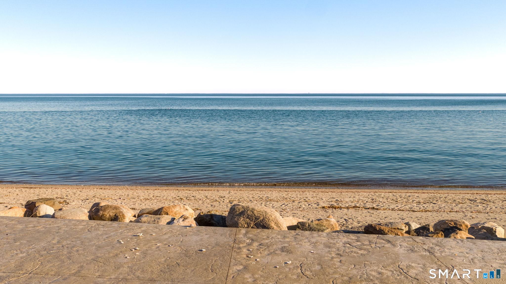 Image 4: Large River Rocks line the expansive patio and create a nice view to the water
