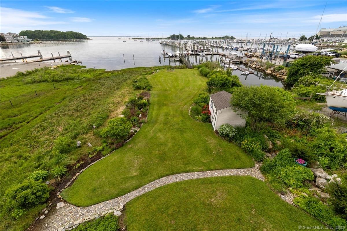 Image 1: Front yard garden view of dock area and Pine Island Bay.