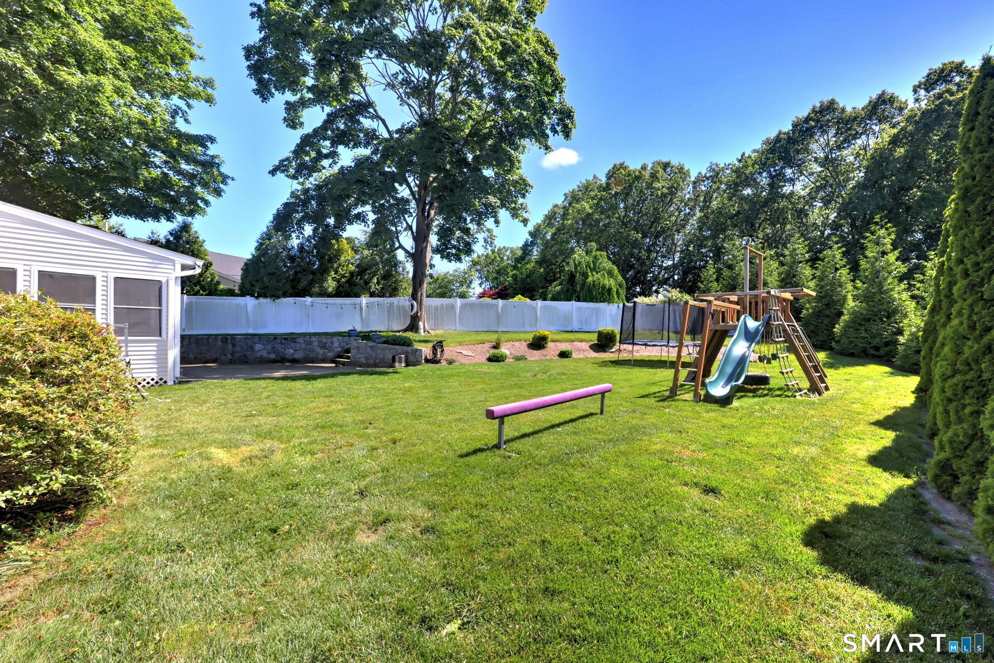 Image 4Back Yard: Wonderful level yard with gorgeous stone walls and landscape.