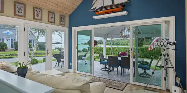 Image 4: Sun room opens to patio with stunning waterviews.