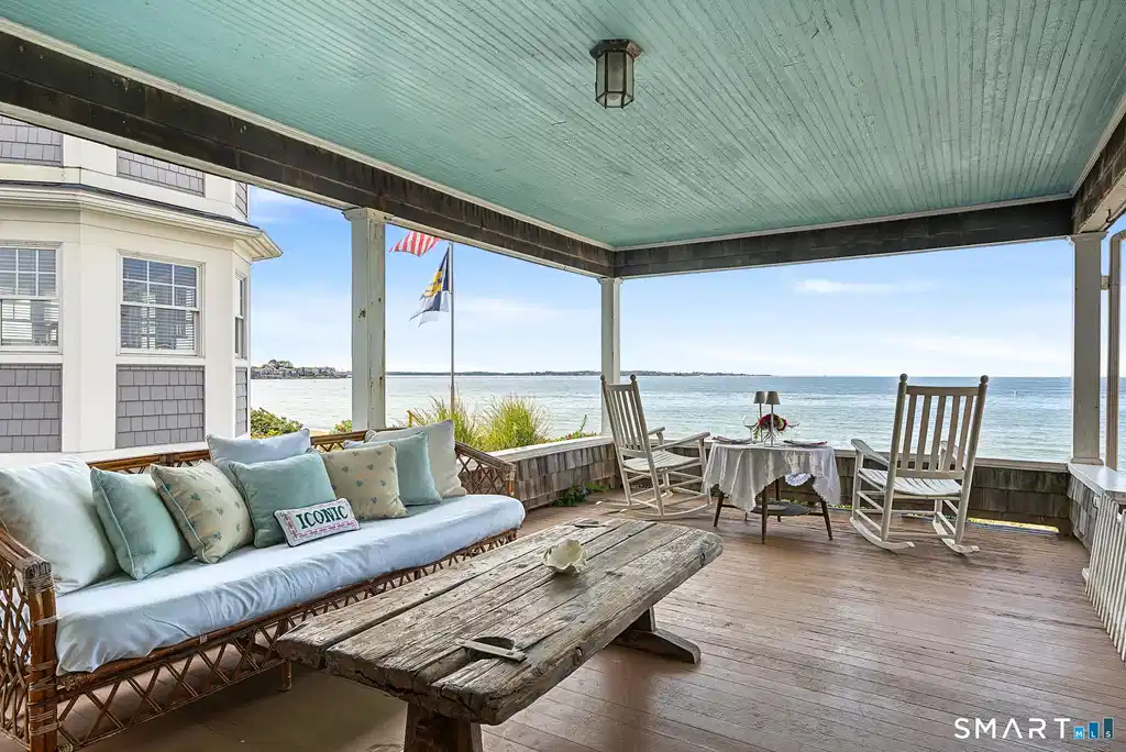 Image 1: Enjoy this covered porch day or evening and enjoy the glorious 180 degree views as well as views of Fisher's Island and Fisher's Island Sound