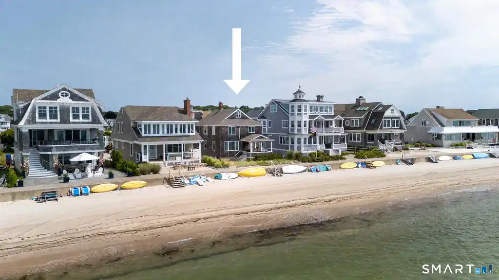 Image 1: Enjoy the gorgeous white sand beach right out your door! (The arrow was added for orientation of house)
