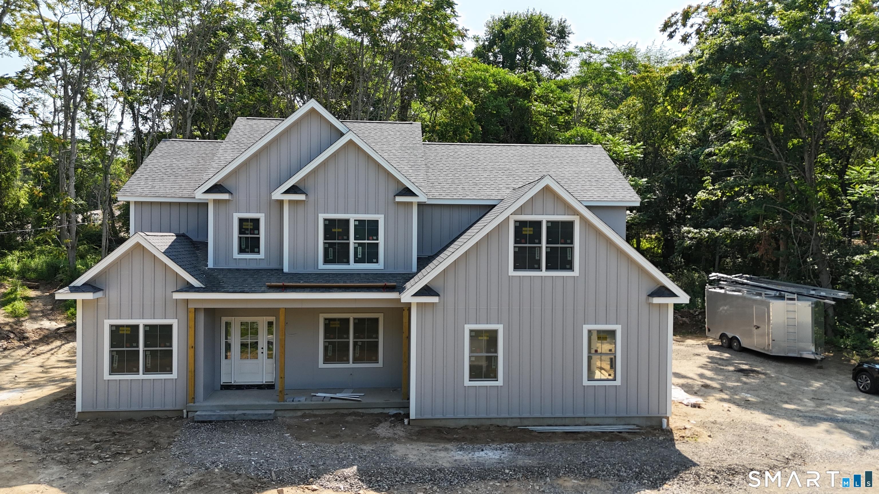 Image 1Front of House: Here's the July Update! Hardie board siding is on; board and batten in the front. Tile is underway! The end is in sight. Come take a look!