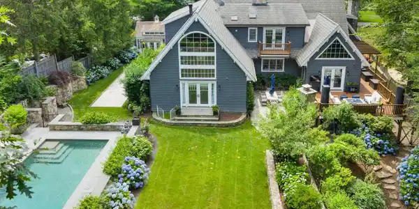Image 2Back of House: Your own private resort: Beautifully landscaped flat yard, pool, patio, outdoor kitchen, Bocce court and Pool house