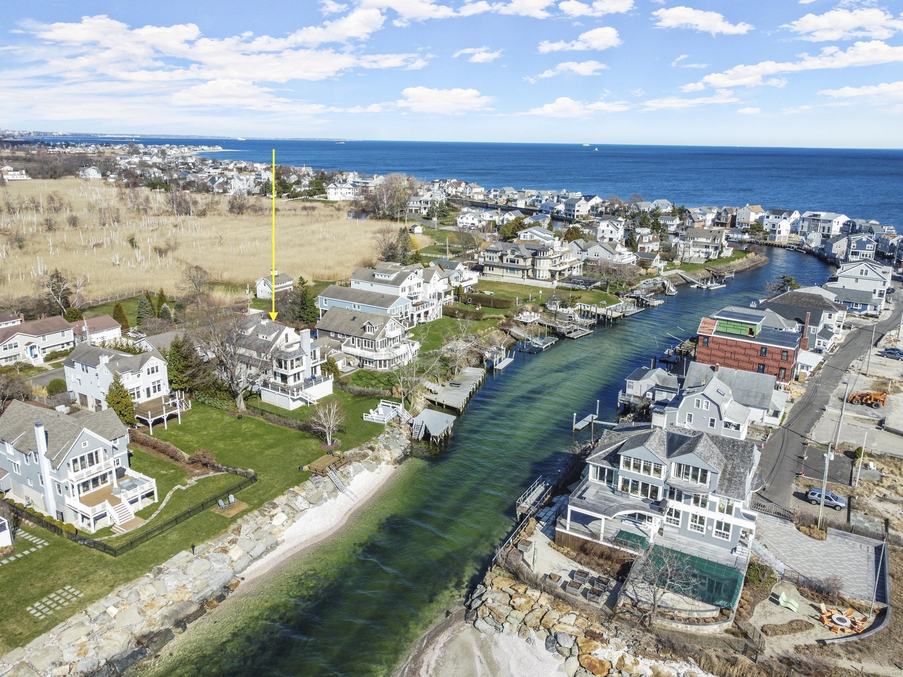 Image 2: The views from every angle at 320 Pine Creek Avenue are stunning; just steps from the creek, opening into the LI Sound, this private waterfront home tucked into the the beautiful and sought after Pine Creek neighborhood offers an idyllic lifestyle.