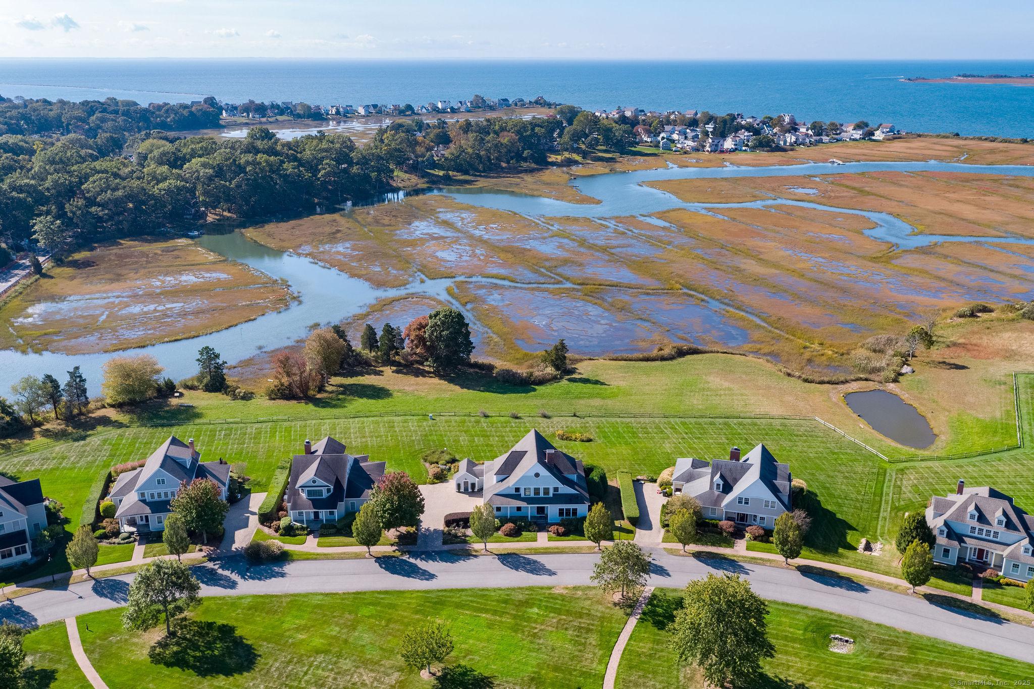 Image 2Aerial View: Located in The Hammocks with breathtaking panorama water views. It captures ever-changing reflections and gorgeous sunsets