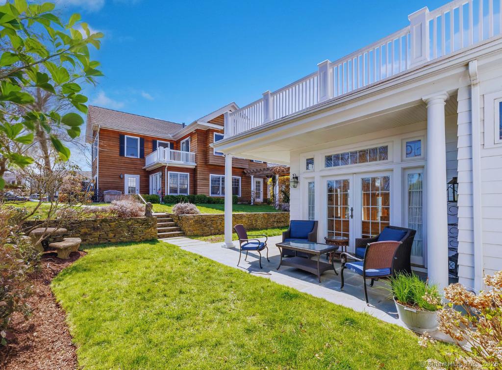 Image 4: The side lawn leading to the gardens and patios.